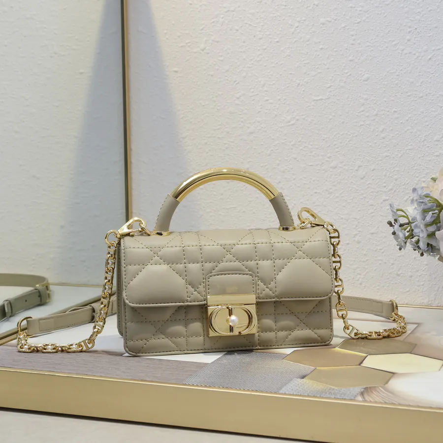 Ange Bucket Bag in Cistian Paris Logo Embossed Gold Tone Metal Handle