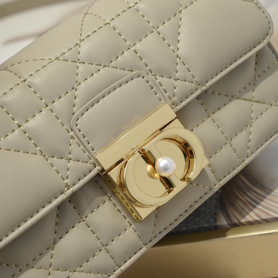 Ange Bucket Bag in Cistian Paris Logo Embossed Gold Tone Metal Handle
