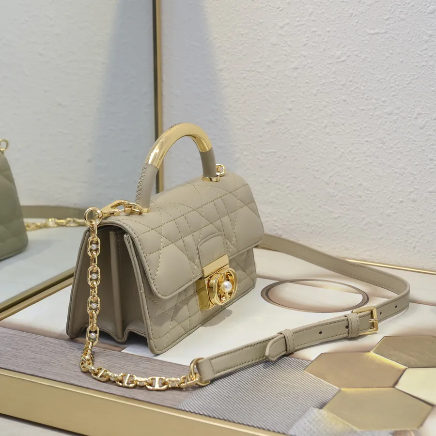 Ange Bucket Bag in Cistian Paris Logo Embossed Gold Tone Metal Handle