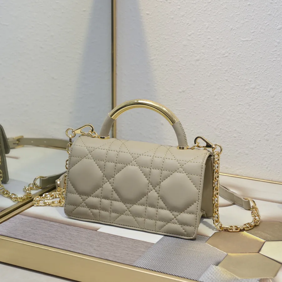 Ange Bucket Bag in Cistian Paris Logo Embossed Gold Tone Metal Handle