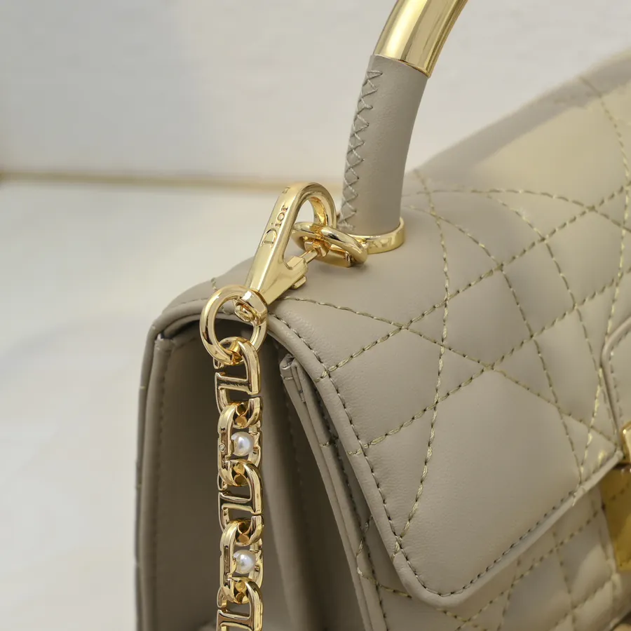 Ange Bucket Bag in Cistian Paris Logo Embossed Gold Tone Metal Handle