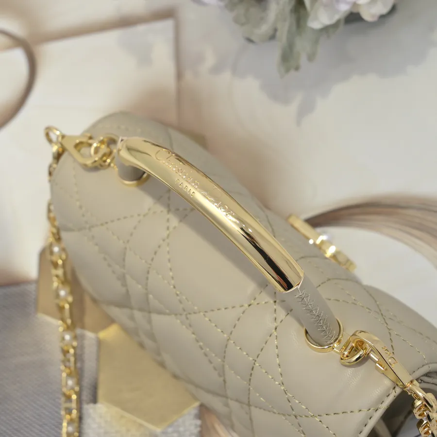 Ange Bucket Bag in Cistian Paris Logo Embossed Gold Tone Metal Handle