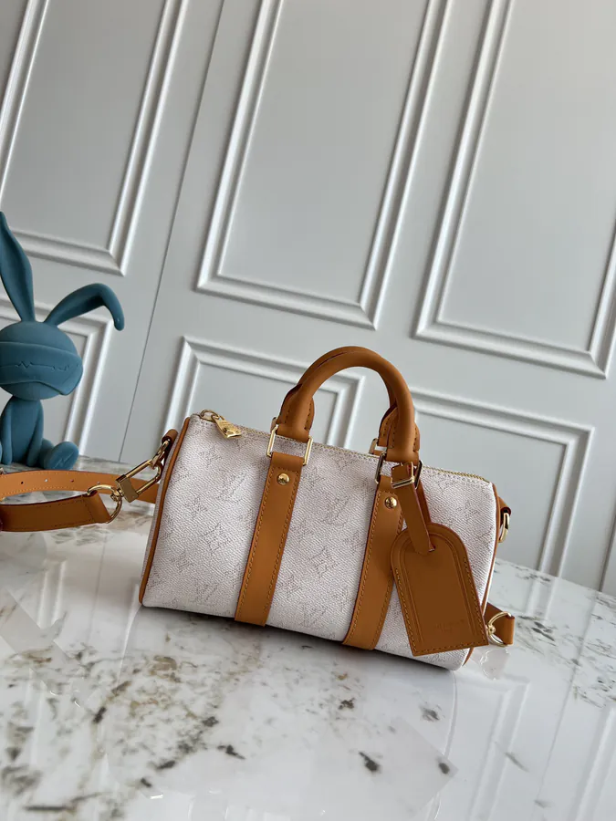 KEEALL BANDOULIÈRE 25 Handbag in Semi Handmade Material